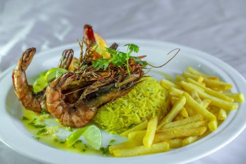 a plate of food with a shrimp and french fries at Euro Star Hotel in Katunayake