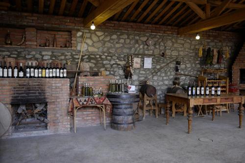 - une salle de dégustation de vin avec un tonneau, une table et des chaises dans l'établissement Brothers khutsishvili wine cellar, à Kisiskhevi