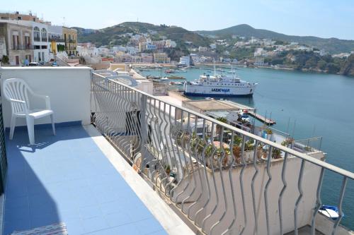 a balcony with a view of a boat in the water at Maridea - Suarella in Ponza