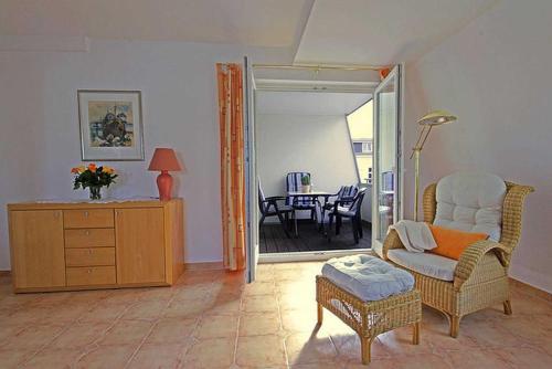 a living room with a chair and a table at Villa Seestern _ Wohnung 10 in Neuhof