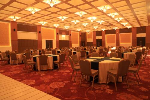 a large banquet hall with tables and chairs at Ramee Royal Resort & Spa - Udaipur in Udaipur