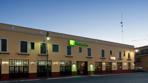 a building with a neon sign on the side of it at Holiday Inn Veracruz-Centro Historico by IHG in Veracruz