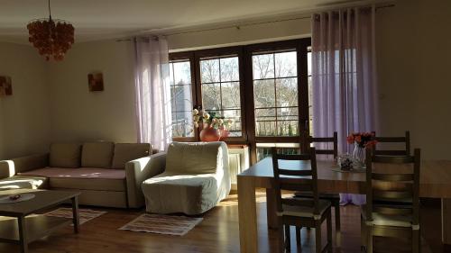 a living room with a couch and a table at Villa Sole in Pruszcz Gdański