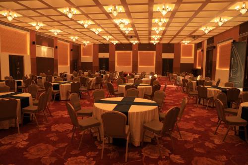 a large banquet hall with tables and chairs at Ramee Royal Resort & Spa - Udaipur in Udaipur