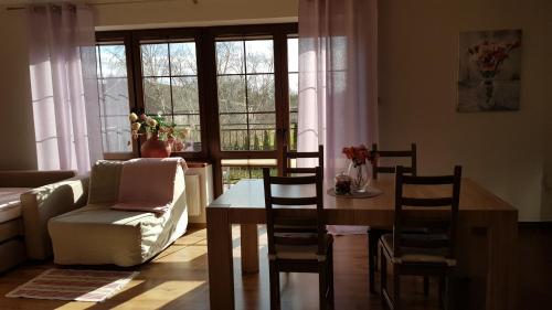 a living room with a table and chairs and a couch at Villa Sole in Pruszcz Gdański