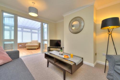 a living room with a couch and a table at Hampson House Stevenage by PAY AS U STAY in Stevenage