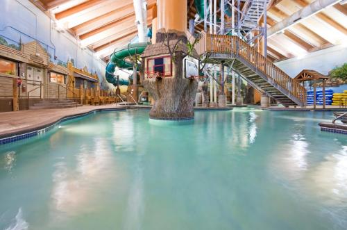 an indoor water park with a water slide at Wyndham Garden Otsego-Minneapolis in Otsego