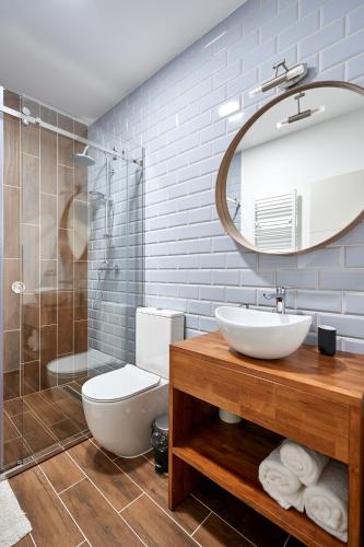 a bathroom with a sink and a toilet and a mirror at La Antigua in Vişeu de Sus