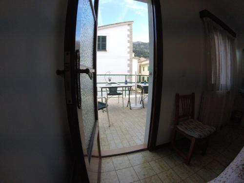 a door to a balcony with a view of a patio at Casa Margarita in Sóller