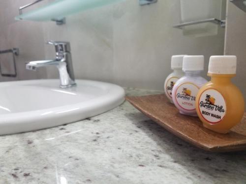a bathroom with two bottles of soap and a sink at Garden Villa Talalla in Talalla
