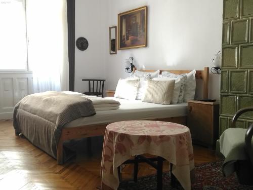 a bedroom with a bed with a table in it at Danube river view close to Parlament in Budapest