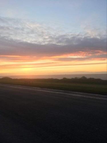 a view of the sunset from a highway at Manor Park Hunstanton pets go free Linen Included in Hunstanton