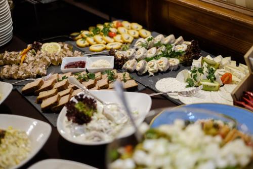 a buffet of different types of food on a table at Hotel Coloseum in Jarosław