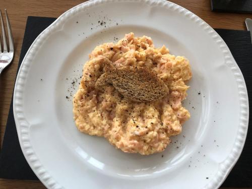 a white plate with a piece of food on it at Adcote House in Llandudno