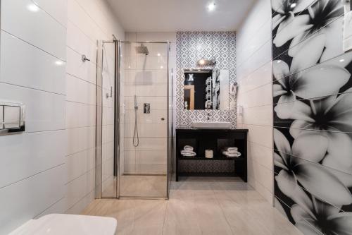 a bathroom with a shower and a sink at Hotel Coloseum in Jarosław
