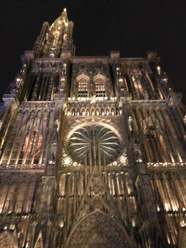 a tall building with a clock tower at night at La Maison de juliette in Saint-Hippolyte