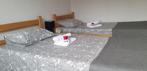 a hotel room with two beds with cups on them at Studio Apartman SAJRA in Kulen Vakuf