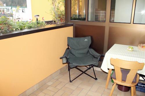a chair sitting next to a table in a restaurant at Post Hostel For Youth, Students and Pilgrims in Lavamünd