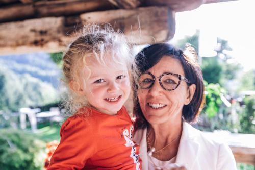 a woman and a little girl posing for a picture at Zur Mühle Wohlfühloase in Trodena