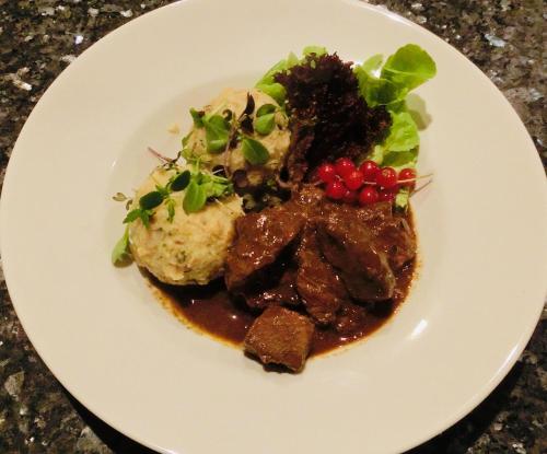 a plate of food with meat and vegetables on a table at Zur Mühle Wohlfühloase in Trodena