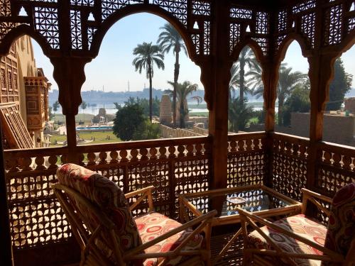 a balcony with chairs and a view of the ocean at Djorff Palace in Luxor