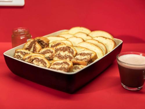 a tray of bread on a table with a glass of coffee at hotelF1 Nantes Est La Beaujoire in Nantes