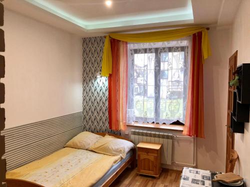 ein kleines Schlafzimmer mit einem Bett und einem Fenster in der Unterkunft Willa Cicha in Rabka-Zdrój