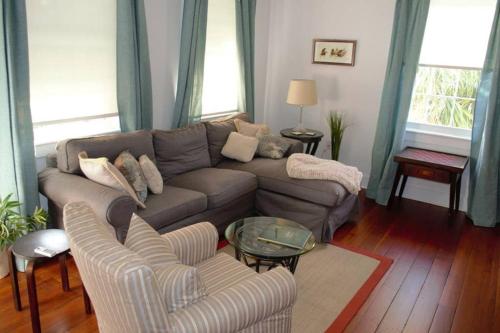 a living room with a couch and a table at Renovated Historic Loft in the Heart of Downtown in Beaufort