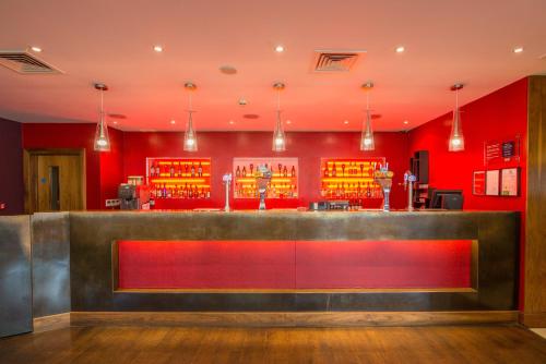a red and white bar in a restaurant at Holiday Inn Norwich City, an IHG Hotel in Norwich