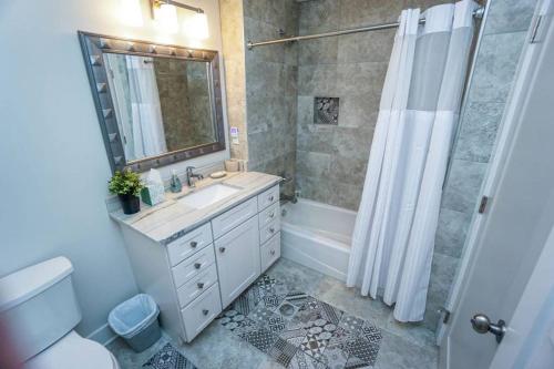 a bathroom with a sink and a shower and a toilet at Beautiful, Modern Getaway in Historic Downtown Beaufort in Beaufort