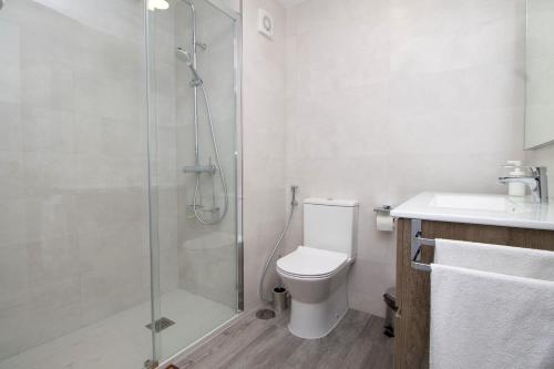 a bathroom with a shower and a toilet and a sink at Santa Amalia 18 by IVI Real Estate in Torremolinos