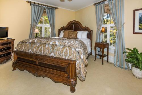 1 dormitorio con cama con marco de madera y piano en Oak Hill On Love Lane Bed and Breakfast Inn en Waynesville