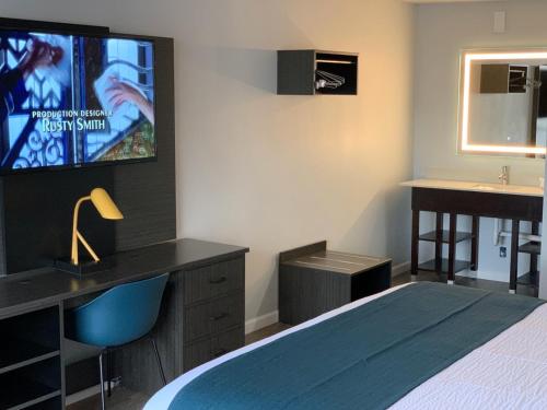a bedroom with a bed and a desk and a sink at Motel 6 Louisville, Ky- Airport/ Fair Expo in Louisville