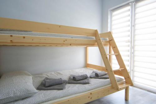 a bunk bed with three pillows on the bottom bunk at Ośrodek Wypoczynkowy Słońce Bobolin in Dąbki