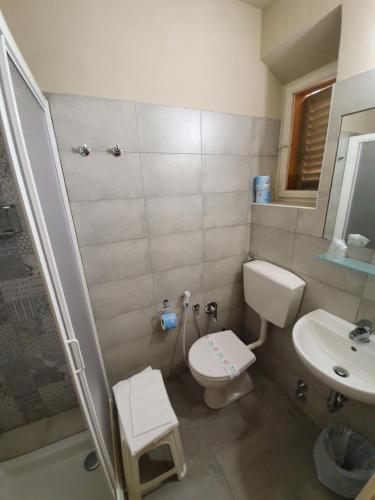 a bathroom with a toilet and a sink and a shower at Hotel Giovanna in Montecatini Terme