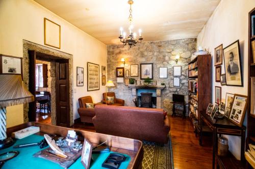 a living room with a couch and a stone wall at Casa Nobre do Correio-Mor in Ponte da Barca
