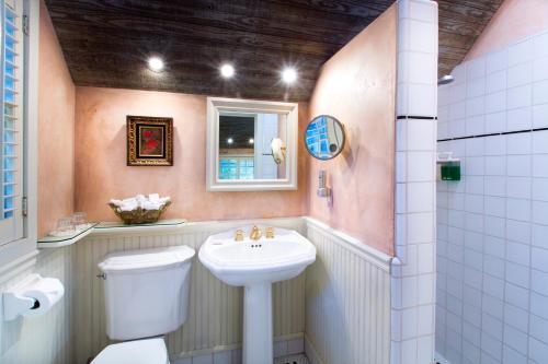 a bathroom with a toilet, sink, and bathtub at Simpson House Inn in Santa Barbara
