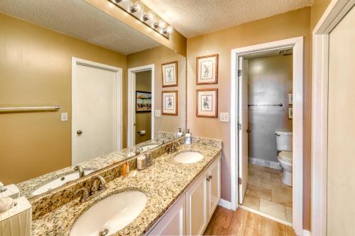 a bathroom with two sinks and a toilet at Summer House 309 in Isle of Palms