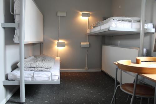 a room with two bunk beds and a table at Danhostel Herning in Herning