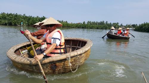 a group of people in boats on a river at Sunny Riverside Homestay in Hoi An