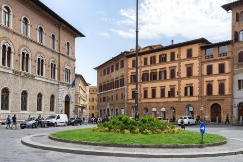 a street in a city with buildings and a roundabout at Domus Nannini SPA - L' Arco di Matteotti in Siena
