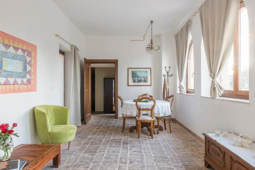 a dining room with a table and chairs in a room at Torre della Loggia - Dimora Storica - Ortona in Ortona