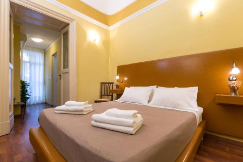 a bedroom with a bed with towels on it at B&B Teatro Bellini in Catania