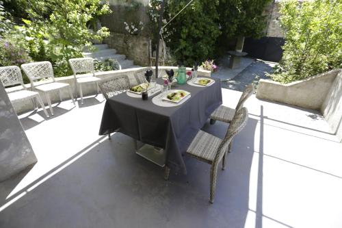 a table with plates of food on a patio at Chambre d'hôtes couvent d'Alando in Alando