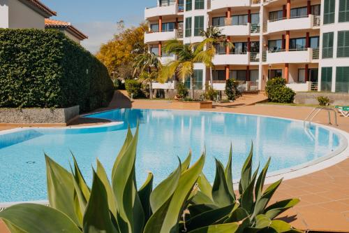 a swimming pool in front of a building at Funchal Lounge Apartment by Amazing Madeira in Funchal