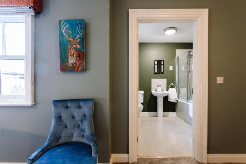 a bathroom with a painting of a deer on the wall at Ralph's in Moira