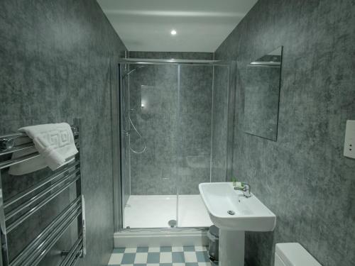 a bathroom with a shower and a toilet and a sink at The Royal Hotel and Bar in Lancaster