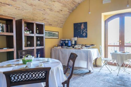 a room with a table, chairs and a television at Torre della Loggia - Dimora Storica - Ortona in Ortona