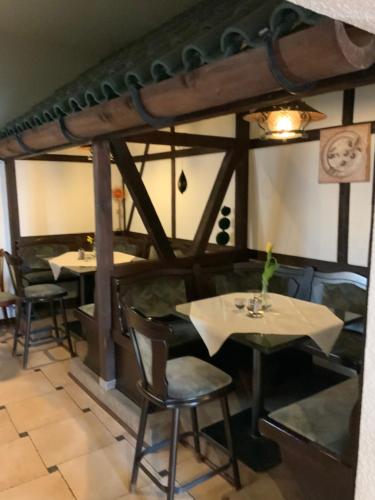 a restaurant with tables and chairs in a room at Bluhm's Hotel & Restaurant am Markt in Kyritz
