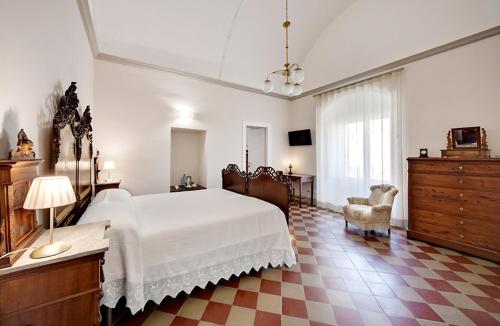 a large bedroom with a white bed and a dresser at Epoca - Camere con stile in Ragusa